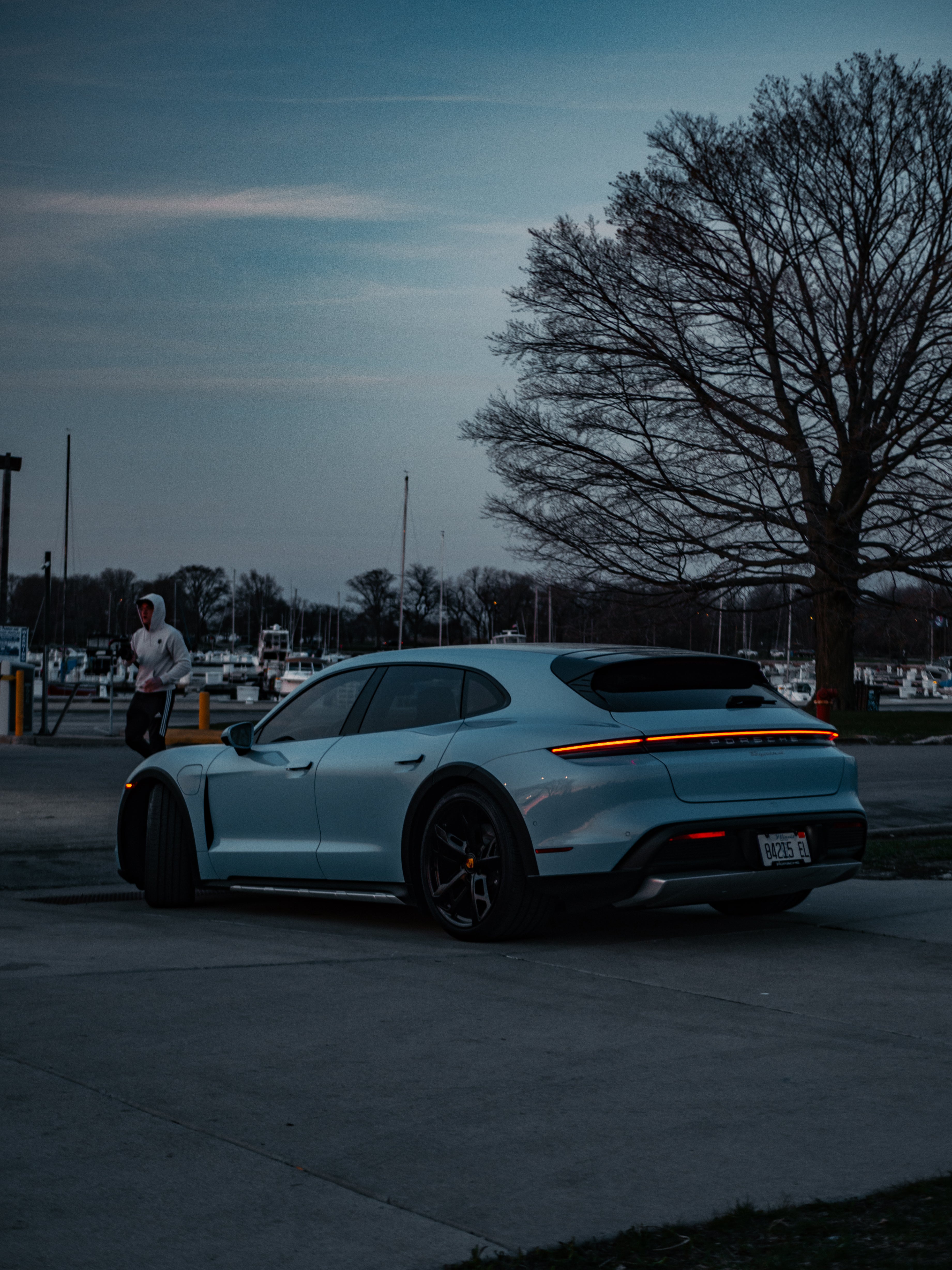 Porsche Taycan 4 rear view featuring sleek taillights, sporty design, and electric performance details.