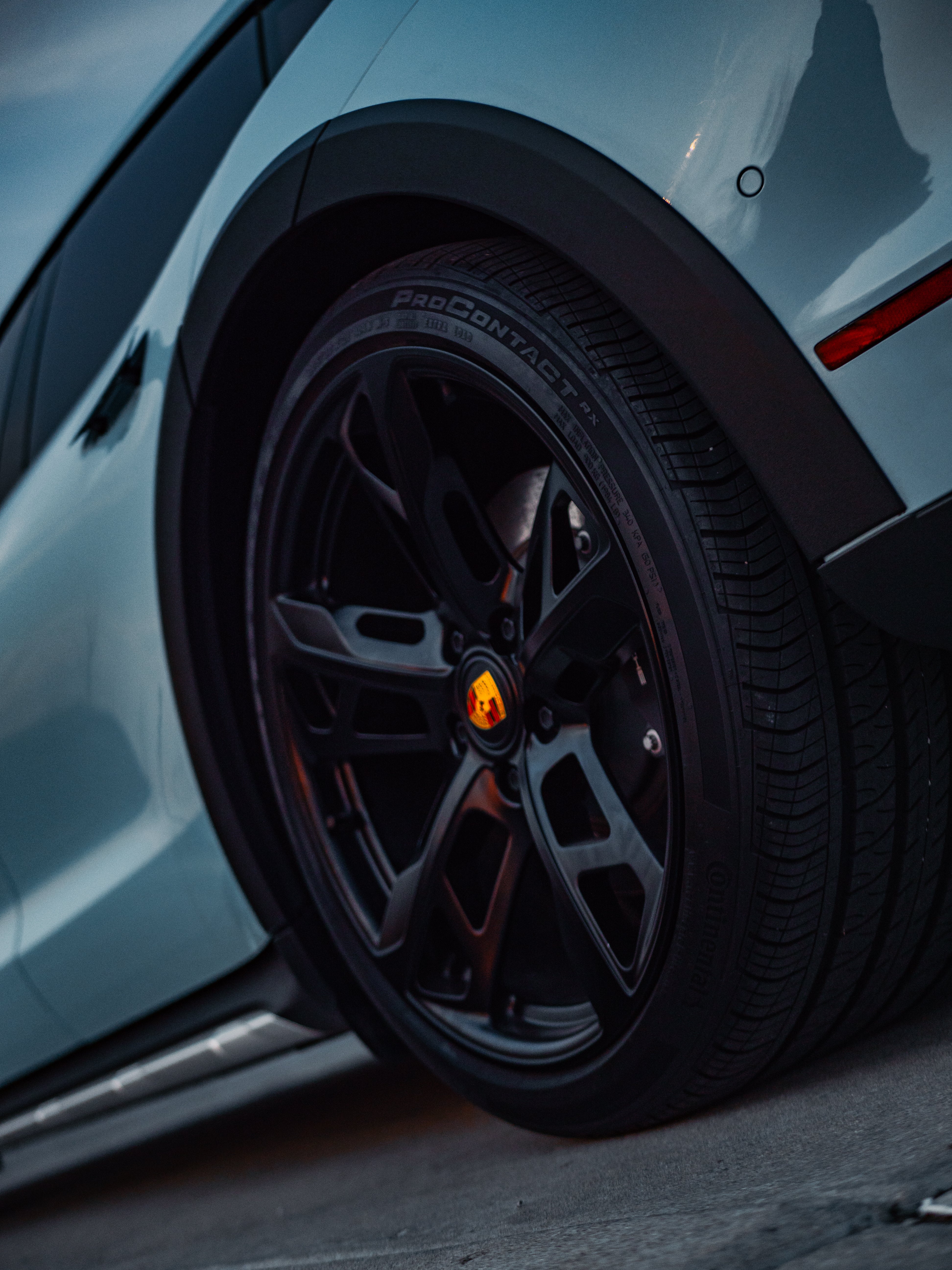 Porsche Taycan 4 close-up of premium alloy wheels with bold design and sleek detailing, showcasing its electric sports car craftsmanship.