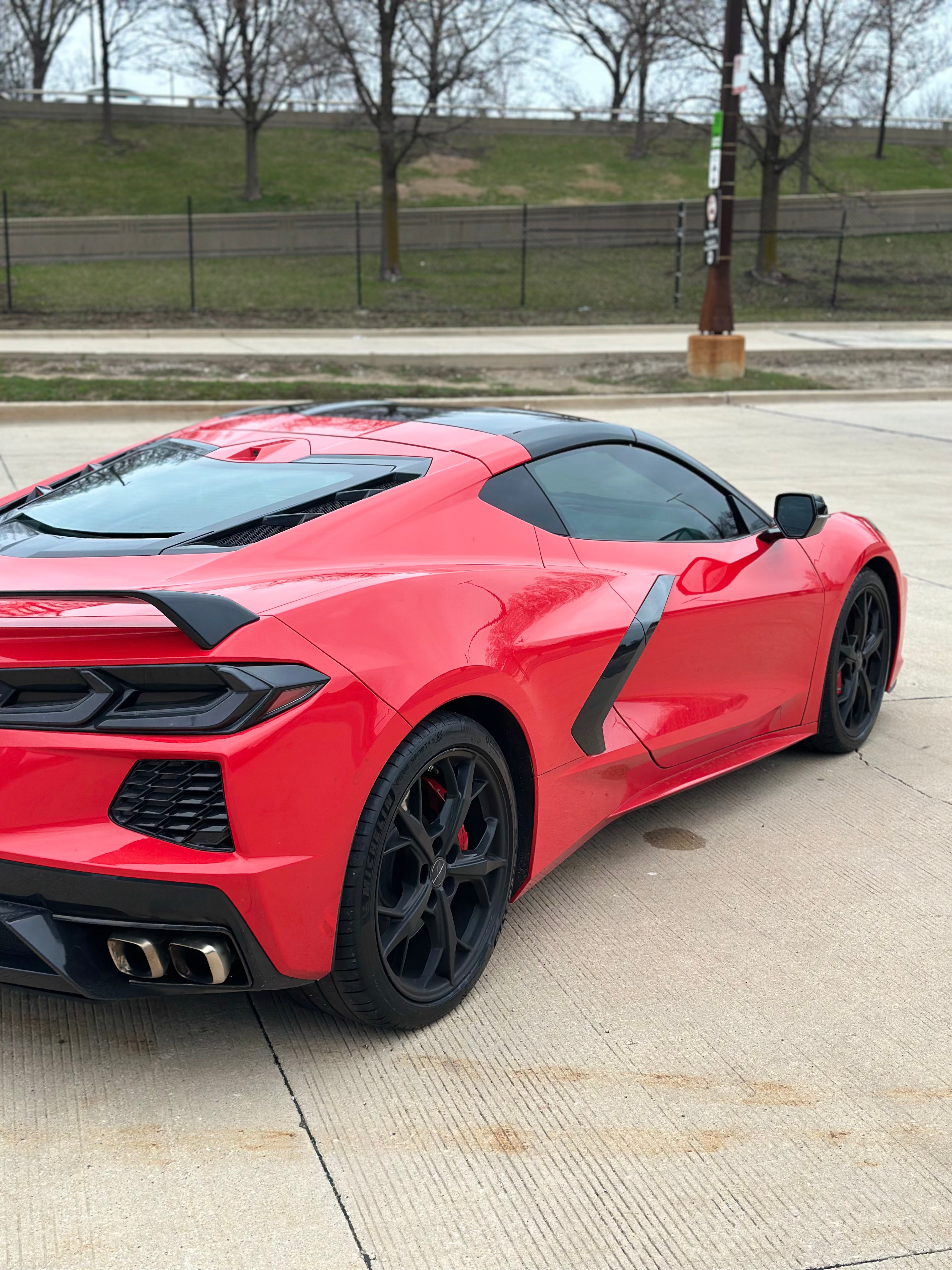 C8 Corvette rear view featuring bold taillights, sporty exhaust, and sleek red exterior design.