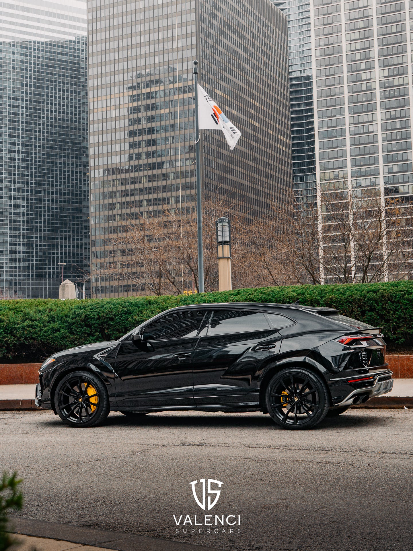 Lamborghini Urus front driver-side corner view showcasing bold black exterior, sleek headlights, and luxury SUV design.