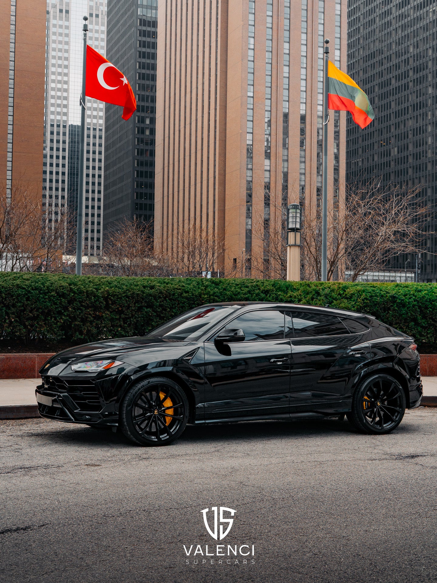 Lamborghini Urus front driver-side corner view showcasing bold black exterior, sleek headlights, and luxury SUV design.