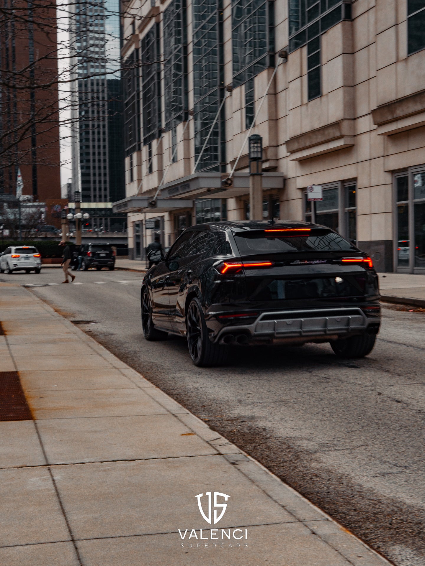 Lamborghini Urus rear view featuring sporty exhaust, bold black exterior, and modern taillights.