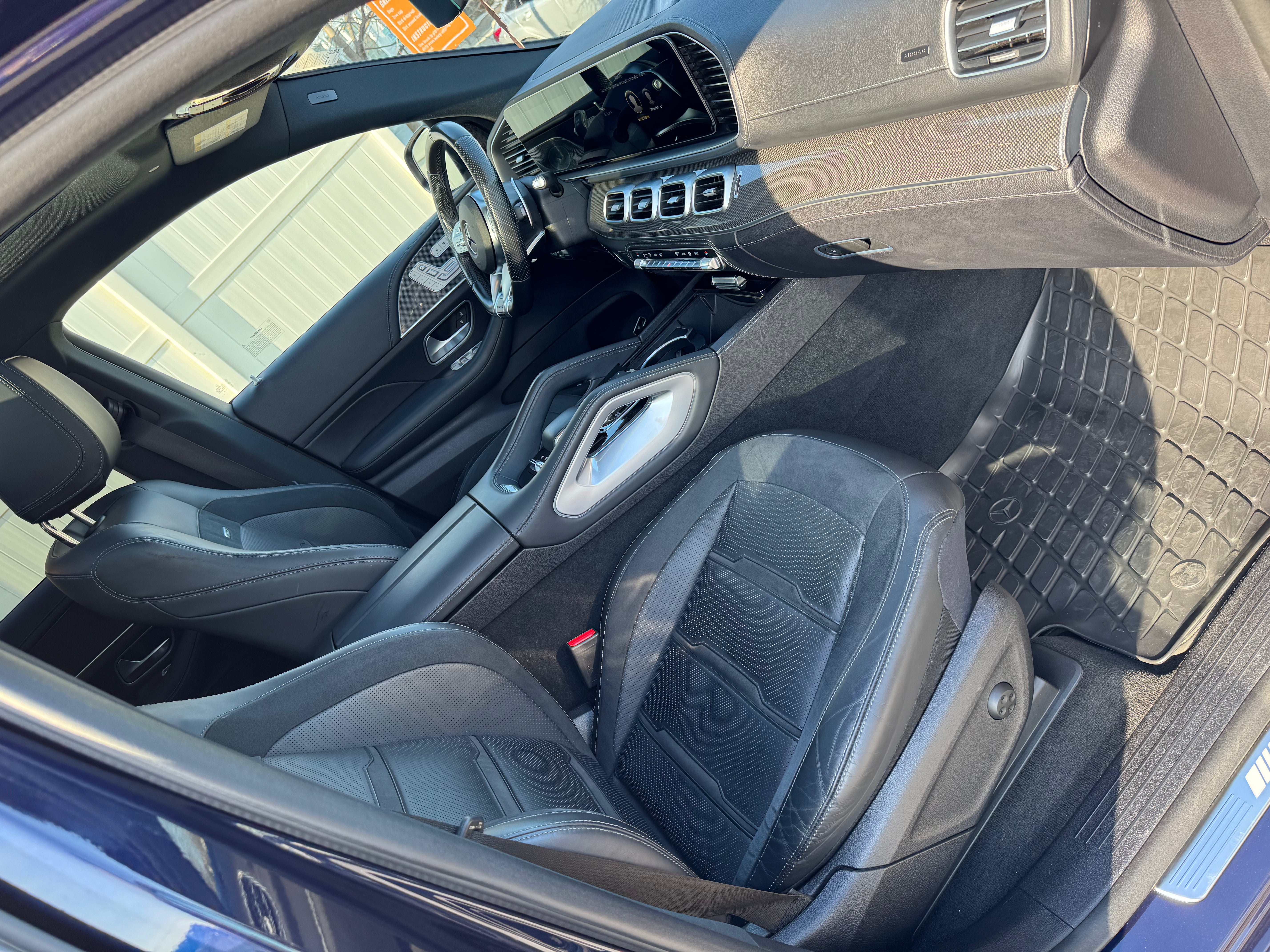 Mercedes-AMG GLE 53 front passenger side view showcasing the sleek exterior design, bold grille, and premium alloy wheels.